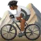 Person Mountain Biking: Medium-Dark Skin Tone emoji on iPhone
