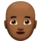 Man: Medium-Dark Skin Tone, Bald emoji on iPhone