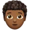 Person: Medium-Dark Skin Tone, Curly Hair emoji on iPhone