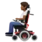 Person in Motorized Wheelchair: Medium-Dark Skin Tone emoji on Apple iOS 17.4