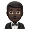 Άνδρας με Σμόκιν: Σκούρος τόνος δέρματος emoji στο iPhone (iOS 15.4)