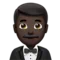 Άνδρας με Σμόκιν: Σκούρος τόνος δέρματος emoji στο iPhone (iOS 17.4)
