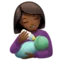 Woman Feeding Baby: Medium-Dark Skin Tone emoji on Apple iOS 16.4