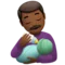 Man Feeding Baby: Medium-Dark Skin Tone emoji on Apple iOS 15.4