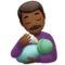 Man Feeding Baby: Medium-Dark Skin Tone emoji on iPhone