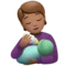 Person Feeding Baby: Medium Skin Tone emoji on Apple iOS 17.4