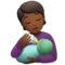 Person Feeding Baby: Medium-Dark Skin Tone emoji on iPhone (iOS 14.6)