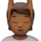 Person Getting Massage: Medium-Dark Skin Tone emoji on Apple iOS 17.4