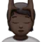 Person Getting Massage: Dark Skin Tone emoji on Apple iOS 16.4